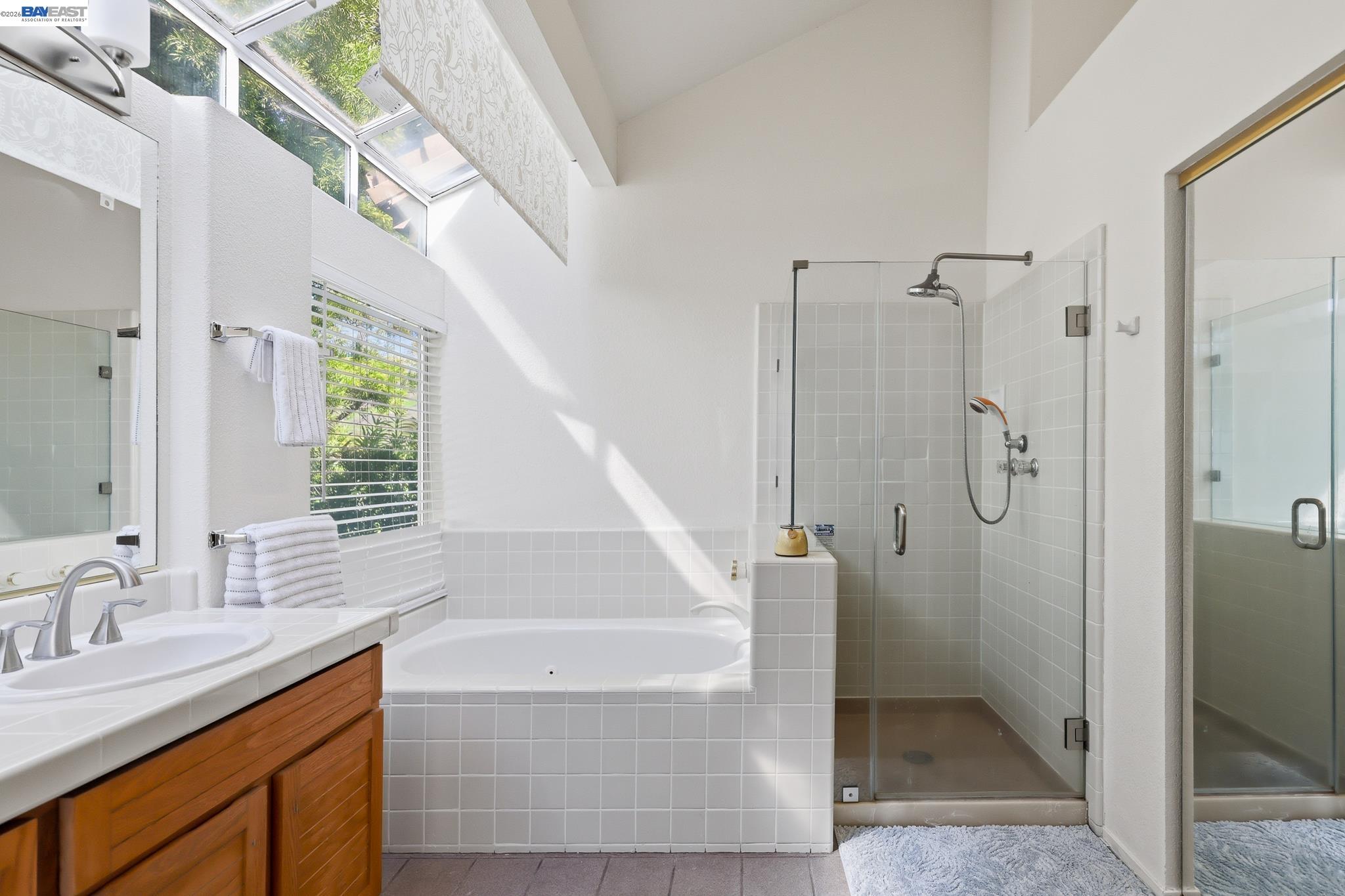 906 Vista Pointe Drive San Ramon, CA 94582 - Photo 45 of 60 a bathroom with a granite countertop sink a mirror and a shower