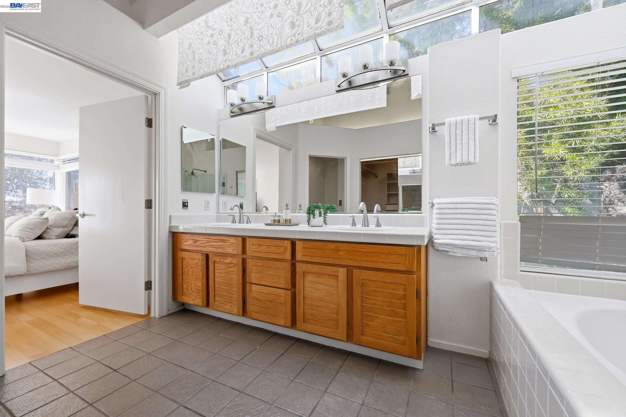 906 Vista Pointe Drive San Ramon, CA 94582 - Photo 47 of 60 a spacious bathroom with a granite countertop sink mirror and bathtub