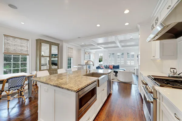 a open kitchen with stainless steel appliances granite countertop a lot of counter space and wooden floors