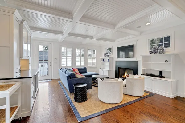 a living room with furniture a fireplace and a table