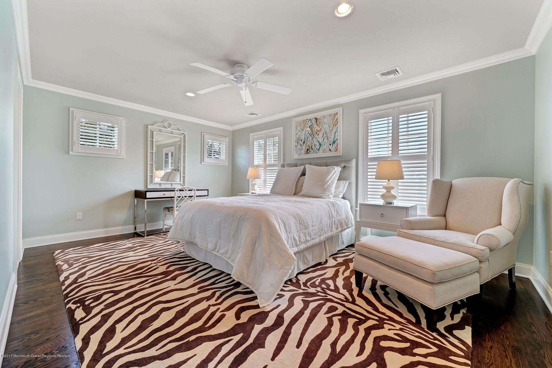 401 Monmouth Avenue Spring Lake, NJ 07762 - Photo 21 of 24 a bedroom with a bed and wooden floor