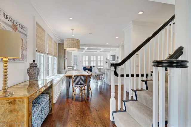 a dining room with wooden floor table and chairs