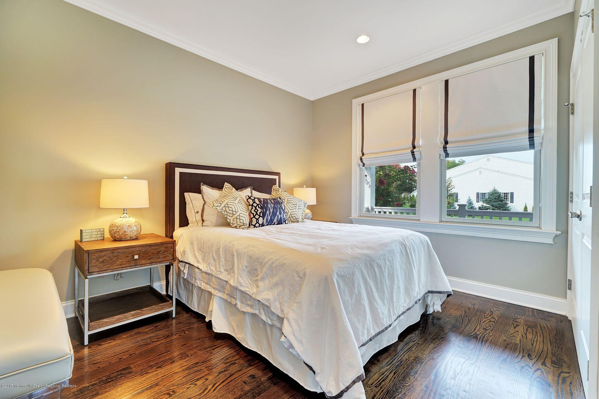401 Monmouth Avenue Spring Lake, NJ 07762 - Photo 8 of 24 a bedroom with a bed wooden floor and window
