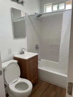 a bathroom with a sink a toilet and bathtub