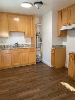 a kitchen with granite countertop wooden cabinets and a counter top space