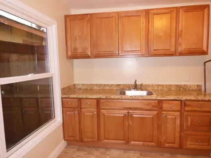 a view of a kitchen with stainless steel appliances granite countertop a stove and a microwave
