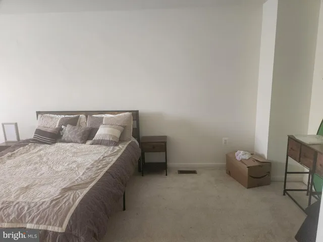 a bedroom with a bed and chair