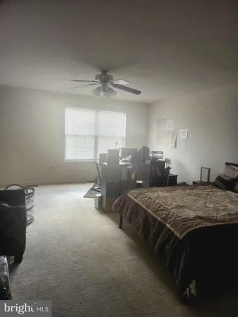 a bed sitting in a spacious bedroom next to a window