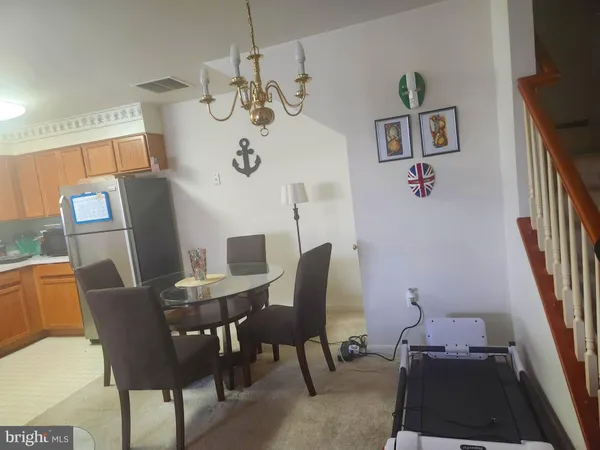 a view of a dining room with furniture wooden floor and a chandelier