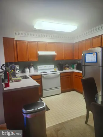 a kitchen with a sink a stove and chairs