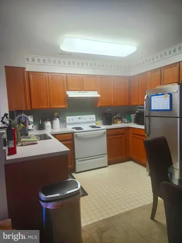 a kitchen with a sink a stove and chairs