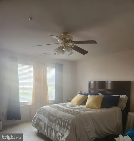 a bedroom with a bed and window