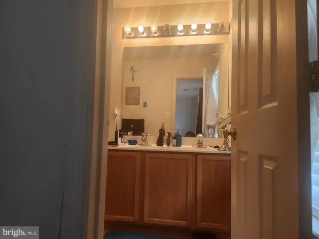 a bathroom with a double vanity sink and a mirror