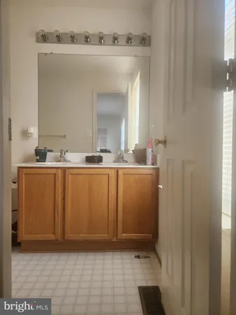 a bathroom with a sink a mirror and a shower