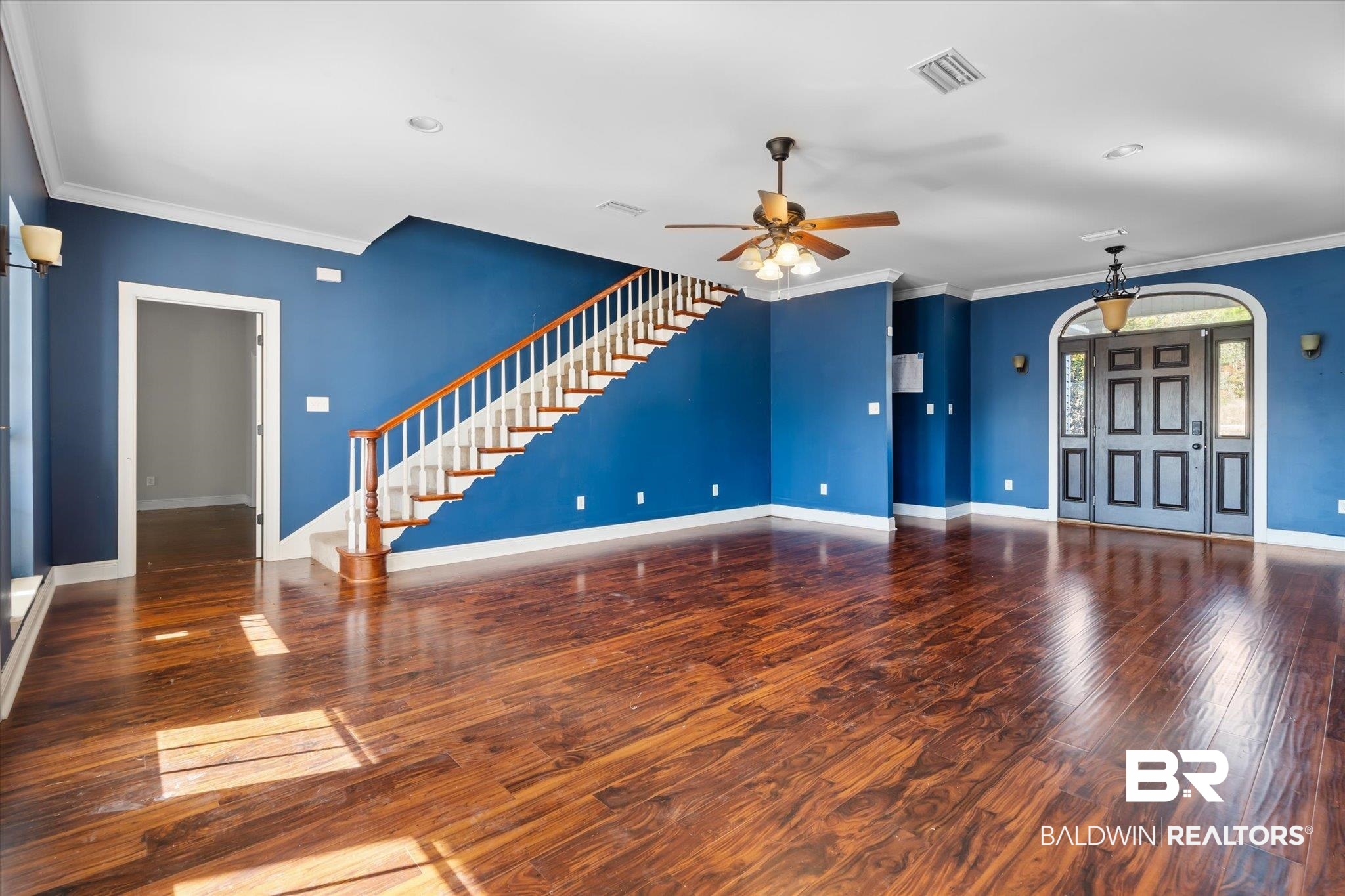 20792 Lonnie Walker Road Citronelle, AL 36522 - Photo 3 of 19 Unfurnished living room featuring ceiling fan, ornamental molding, and hardwood / wood-style floors