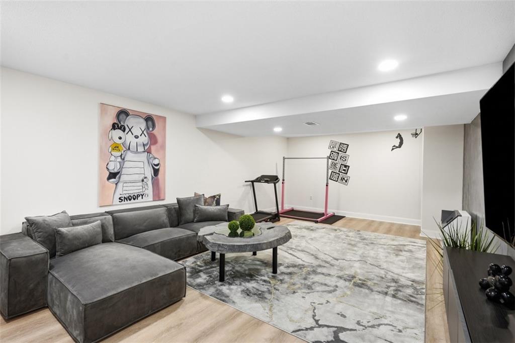 5520 Clearview Road Gibsonia, PA 15044 - Photo 23 of 48 The finished lower level significantly expands the living space, featuring a spacious main room, highlighted by a floating console that can accommodate a large-screen television.