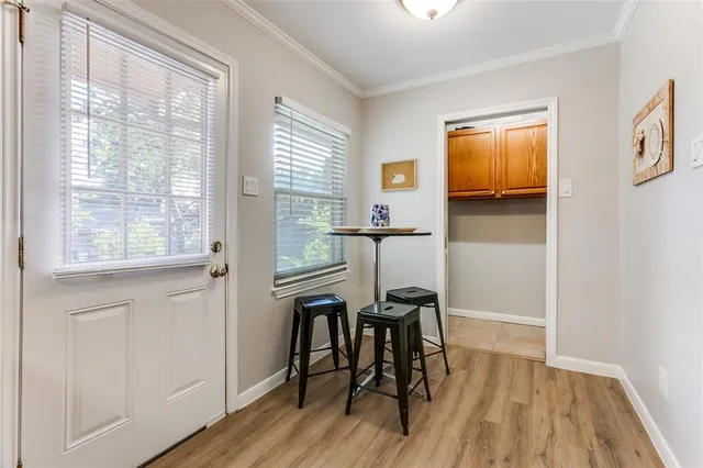 a view of a workspace room with wooden floor lounge chair and windows