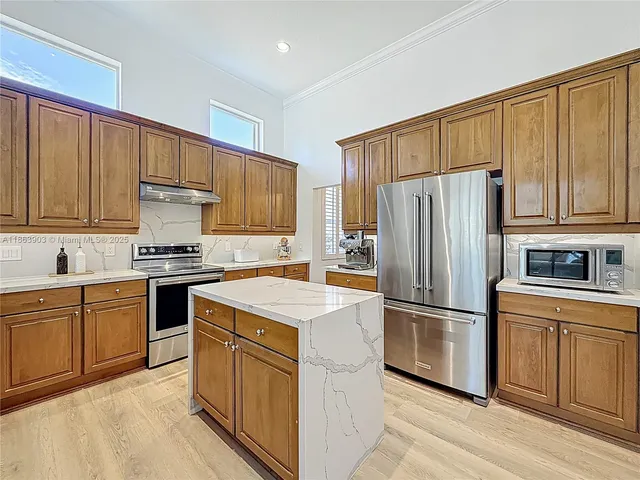 a kitchen with a sink wooden floor and a window