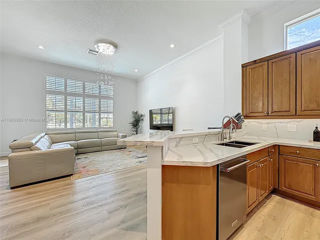 a kitchen with refrigerator cabinets and wooden floor