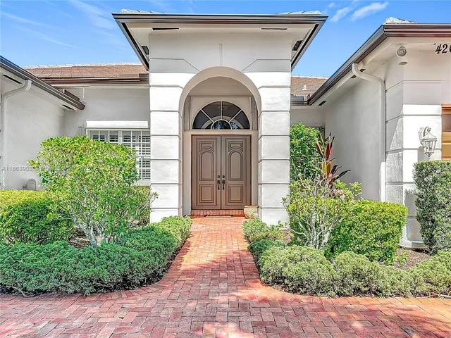 a view of a brick house with potted plants