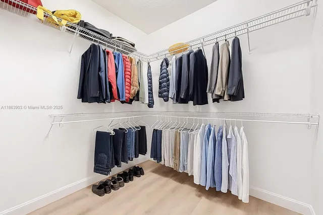 a large bathroom with a double vanity sink a large mirror and a bathtub