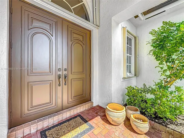 a view of a bedroom with furniture and potted plants
