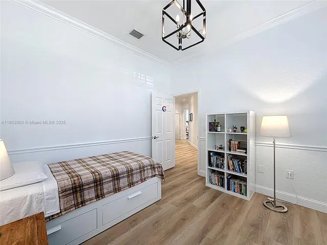 a bedroom with a bed window and a table