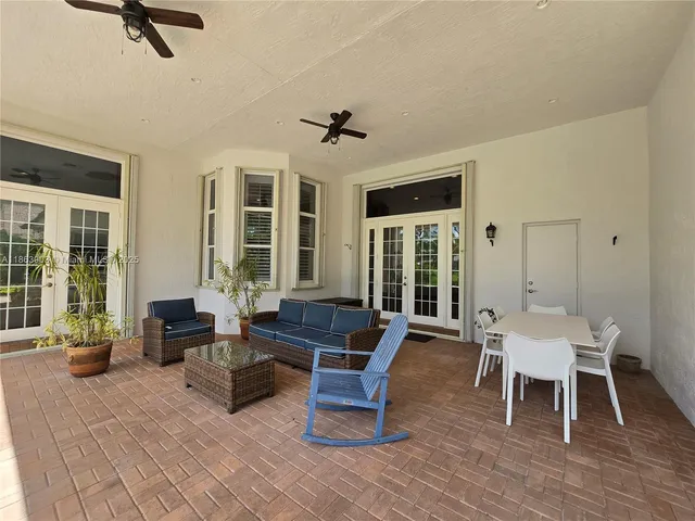 a view of a house with a yard and potted plants