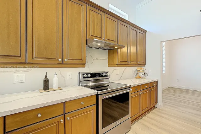 a kitchen with sink cabinets and window