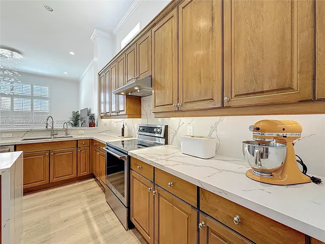 a kitchen with a stove top oven sink and cabinets