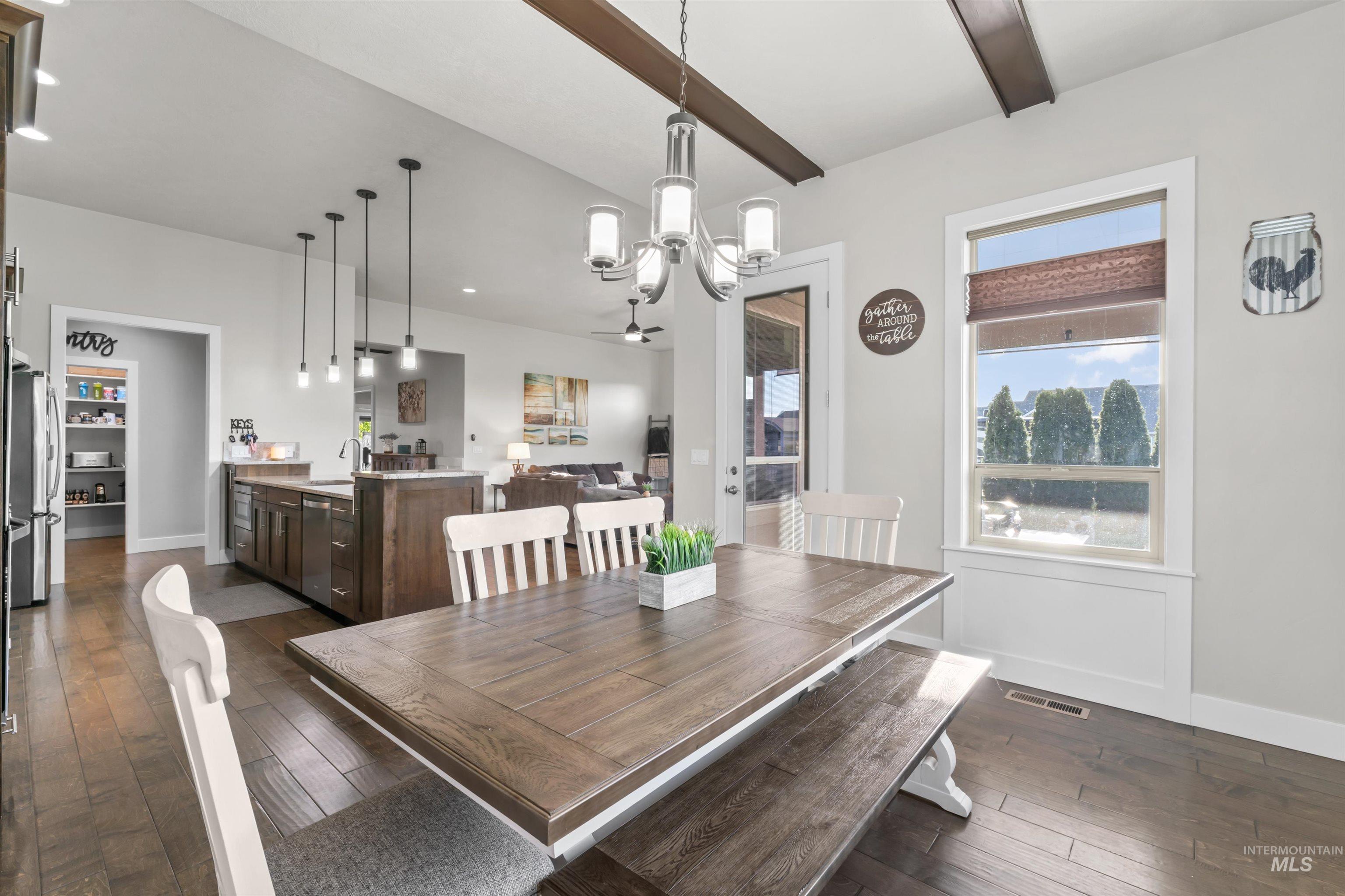 12356 West Rice Road Star, ID 83669 - Photo 13 of 49 Dining space with a chandelier and dark wood-style flooring