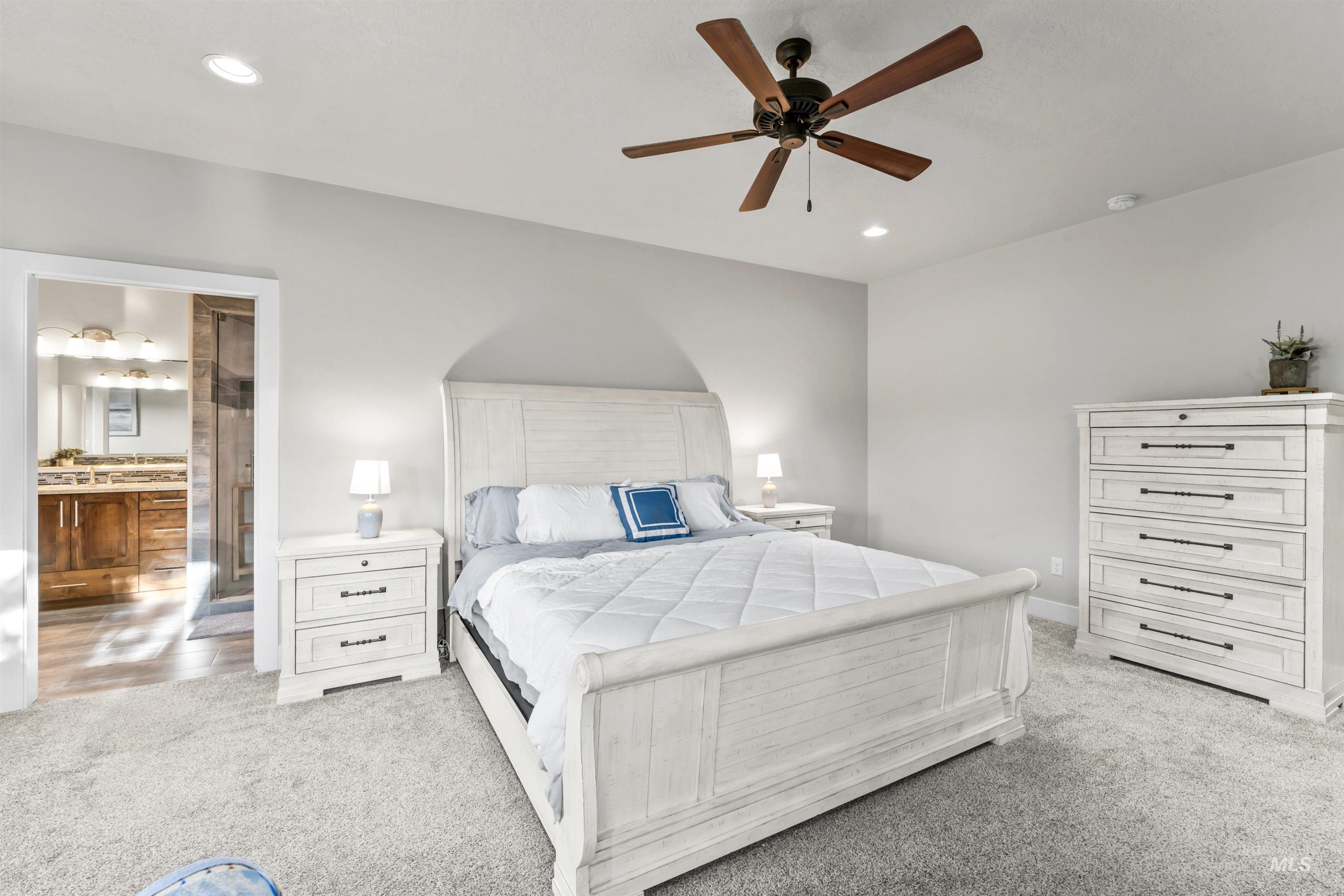 12356 West Rice Road Star, ID 83669 - Photo 19 of 49 Bedroom with light colored carpet, recessed lighting, ceiling fan, and connected bathroom