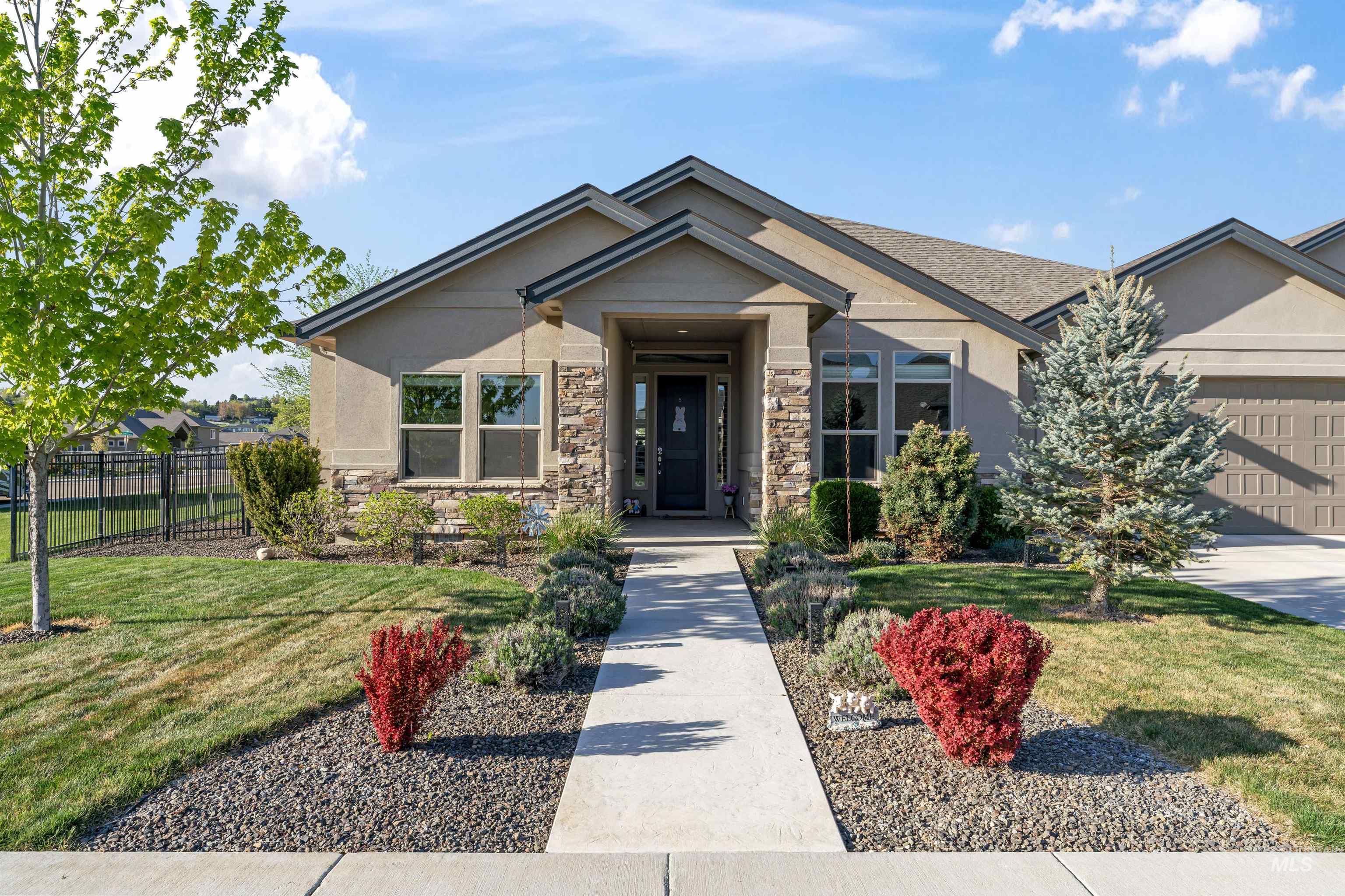 12356 West Rice Road Star, ID 83669 - Photo 2 of 49 View of front of house featuring an attached garage, stone siding, and stucco siding