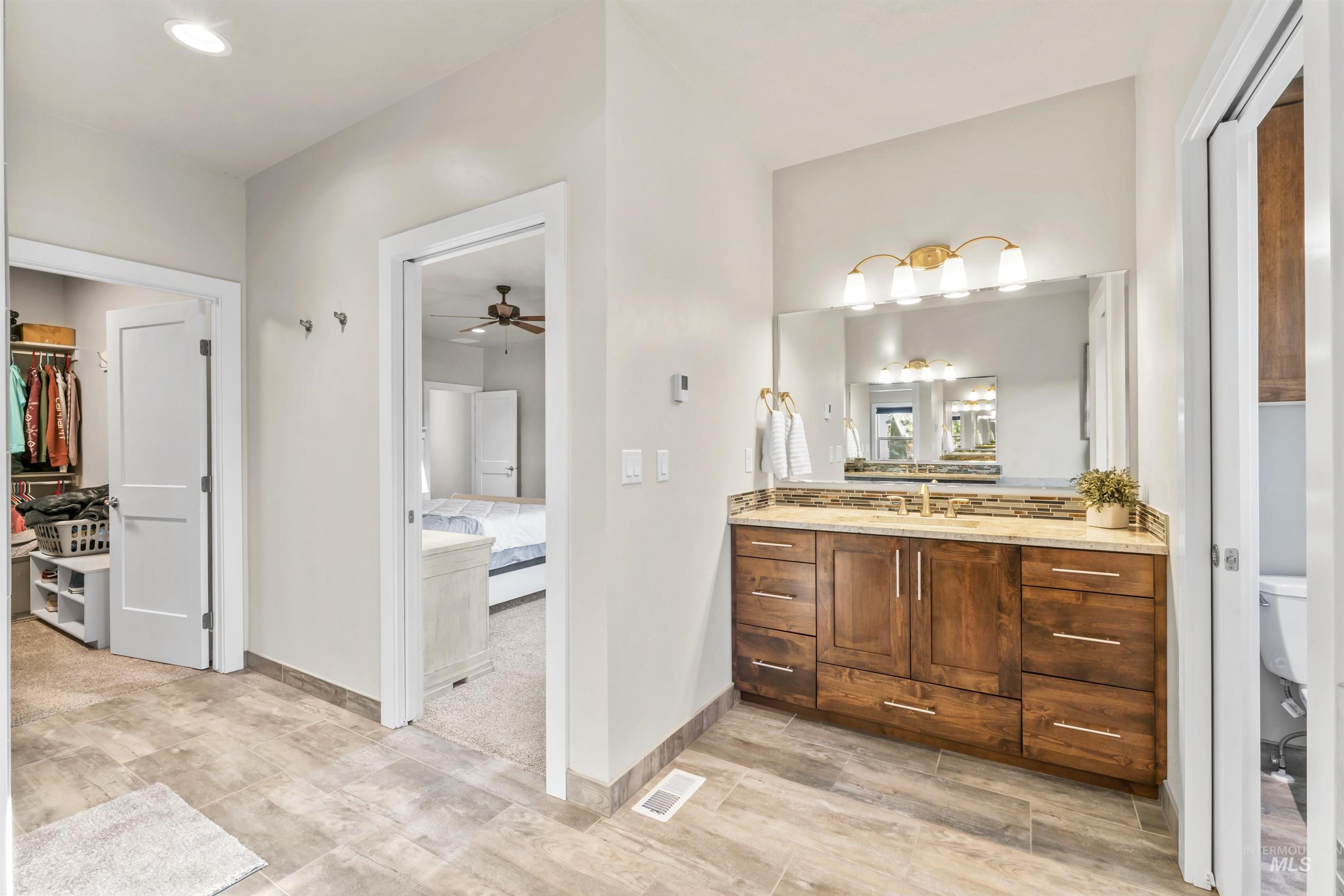 12356 West Rice Road Star, ID 83669 - Photo 23 of 49 Bathroom featuring vanity, a ceiling fan, recessed lighting, and a walk in closet