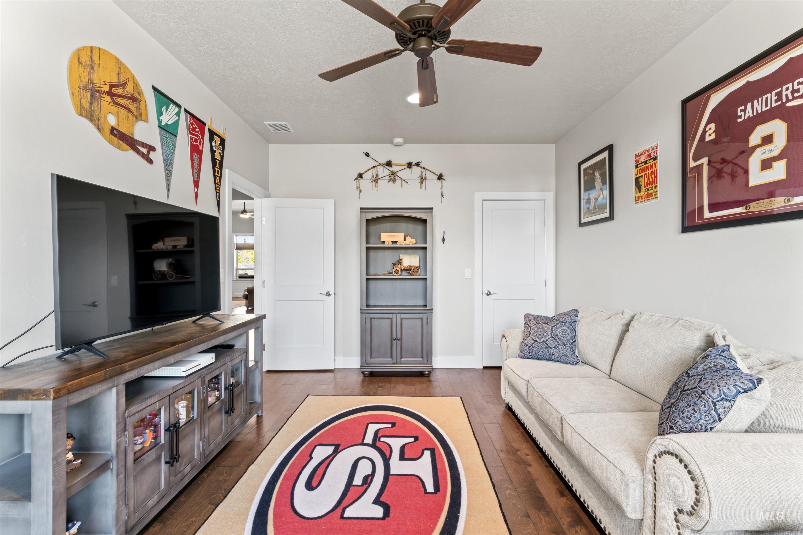 12356 West Rice Road Star, ID 83669 - Photo 31 of 49 Living room featuring dark wood-style floors, ceiling fan, and a textured ceiling