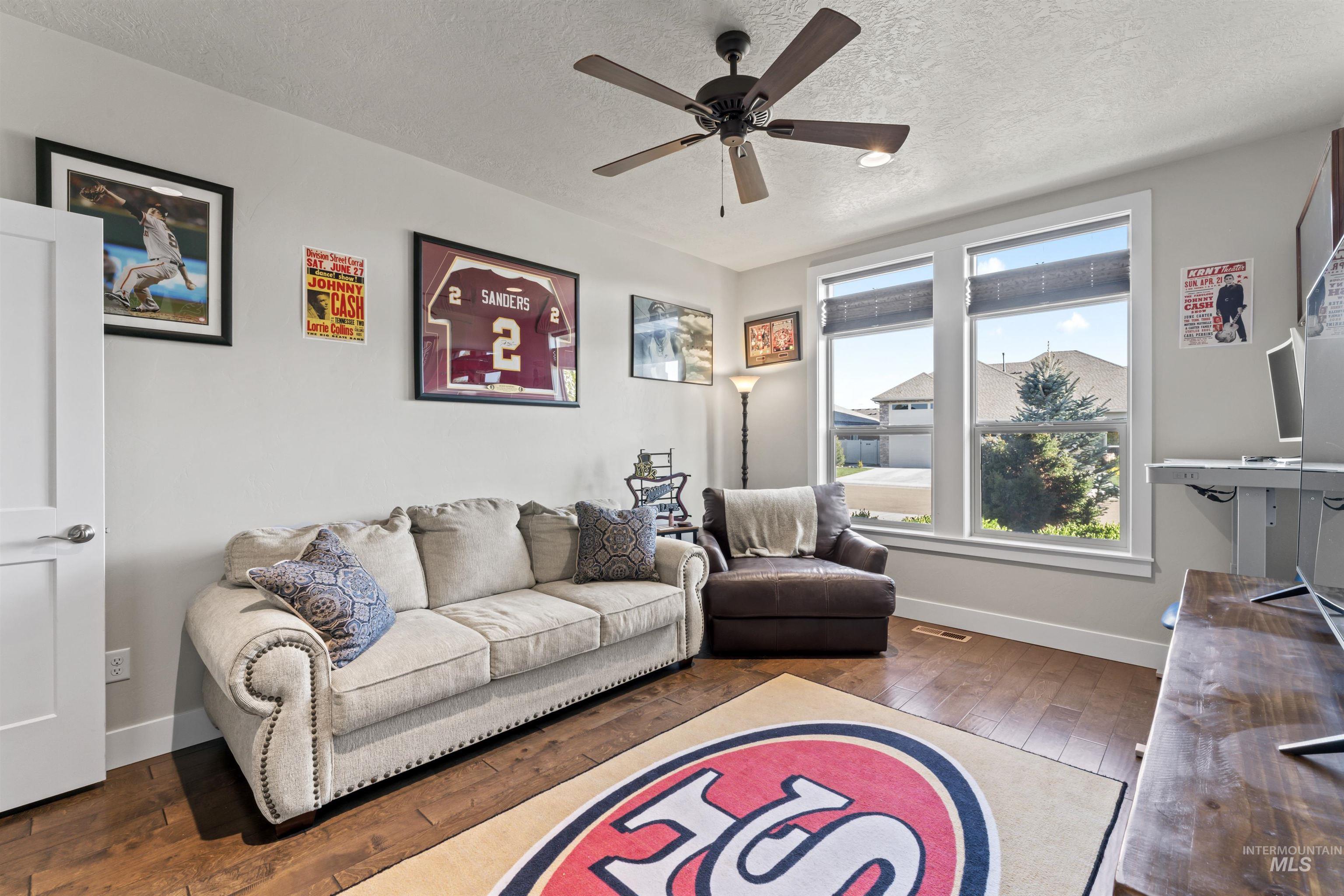 12356 West Rice Road Star, ID 83669 - Photo 32 of 49 Living room featuring hardwood / wood-style flooring, a textured ceiling, and ceiling fan