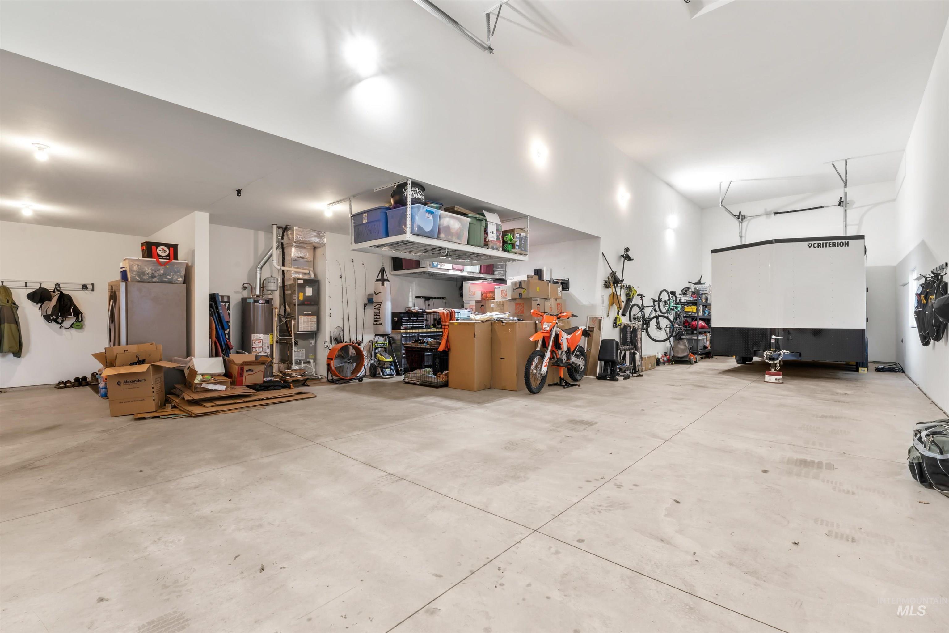 12356 West Rice Road Star, ID 83669 - Photo 39 of 49 Garage featuring water heater, heating unit, and freestanding refrigerator