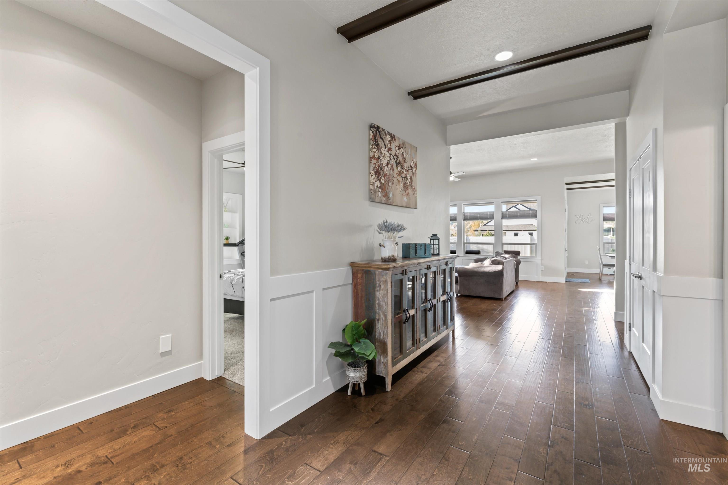 12356 West Rice Road Star, ID 83669 - Photo 4 of 49 Corridor with dark wood-style flooring and a decorative wall