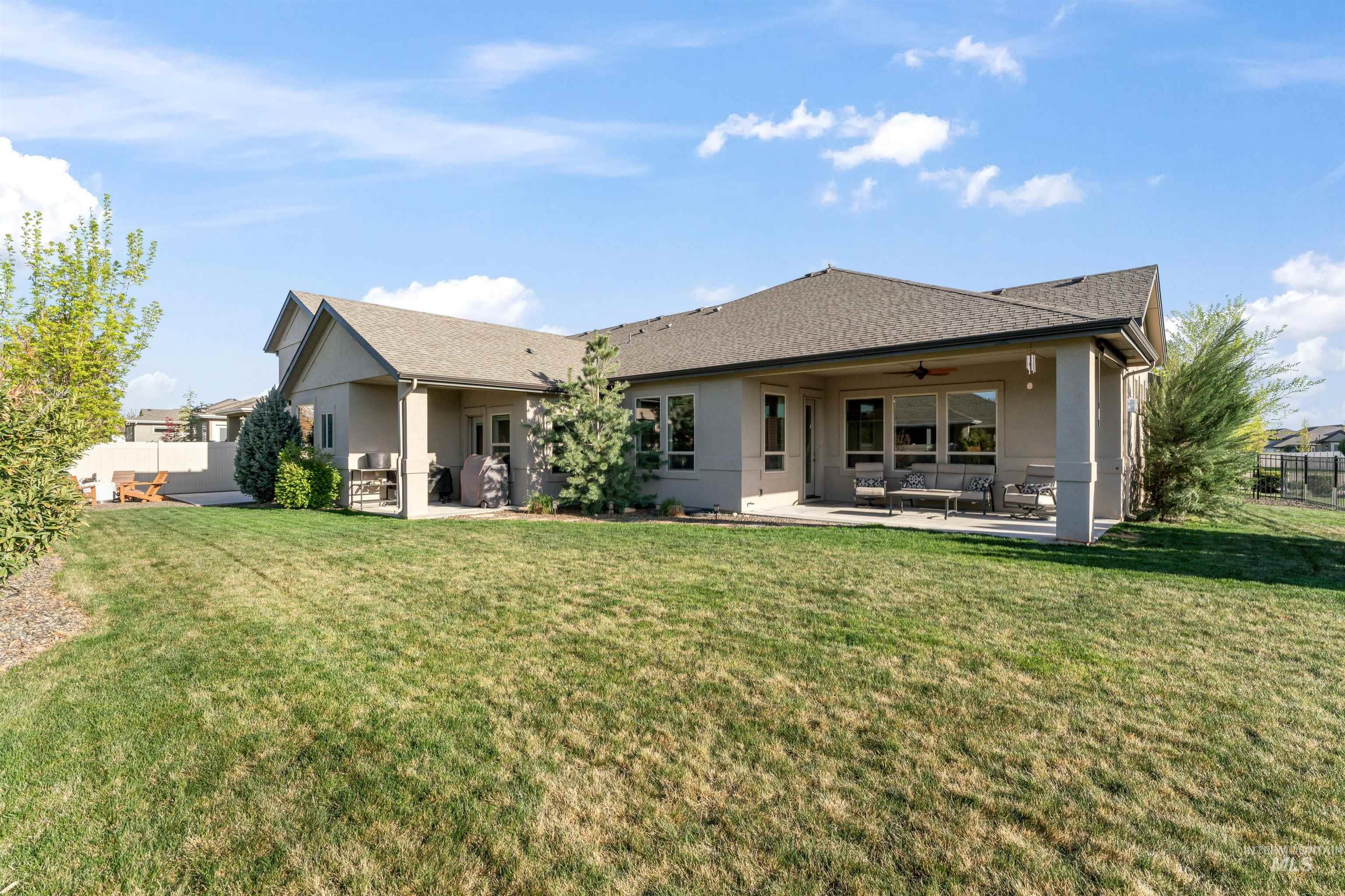 12356 West Rice Road Star, ID 83669 - Photo 44 of 49 Rear view of house with a patio, stucco siding, a ceiling fan, and roof with shingles