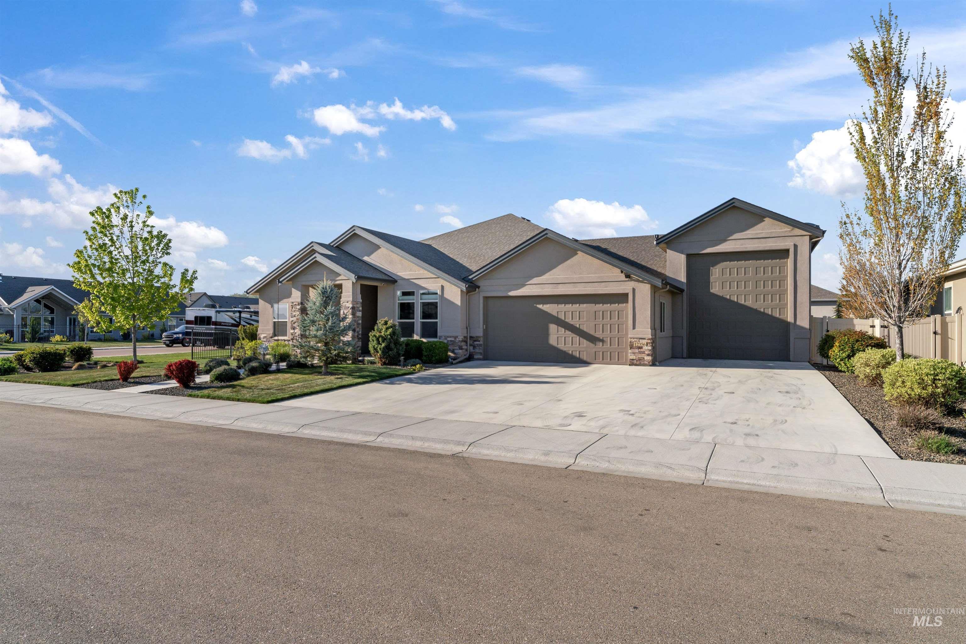 12356 West Rice Road Star, ID 83669 - Photo 47 of 49 View of front facade featuring a garage, concrete driveway, and stone siding