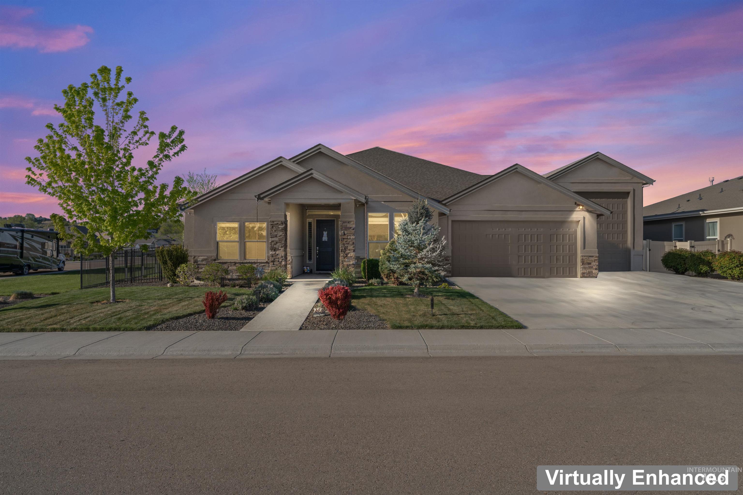12356 West Rice Road Star, ID 83669 - Photo 48 of 49 View of front facade featuring stone siding, an attached garage, and driveway