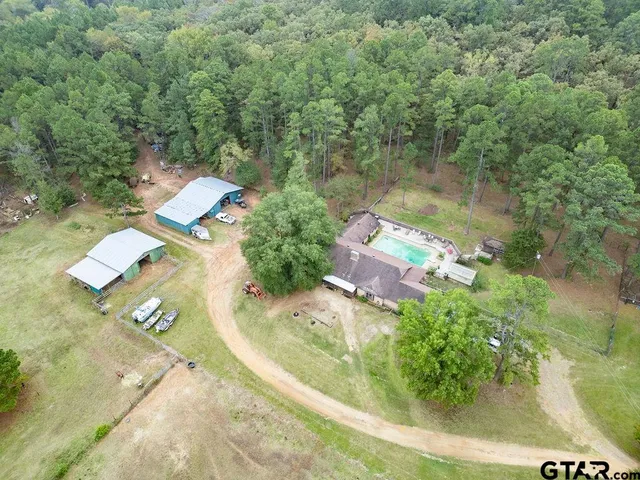 an aerial view of a house with a yard and lake view