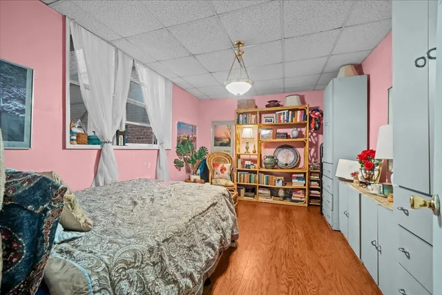 a bedroom with a bed and a dresser in it