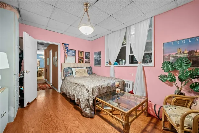 a bed room with a bed window and dresser