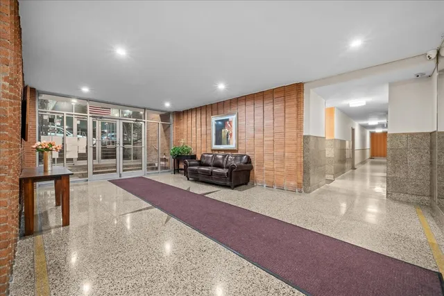 a spacious bedroom with a balcony a bed and glass door