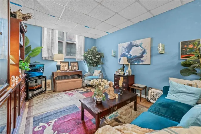 a living room filled with furniture a chandelier a dining table and a chandelier