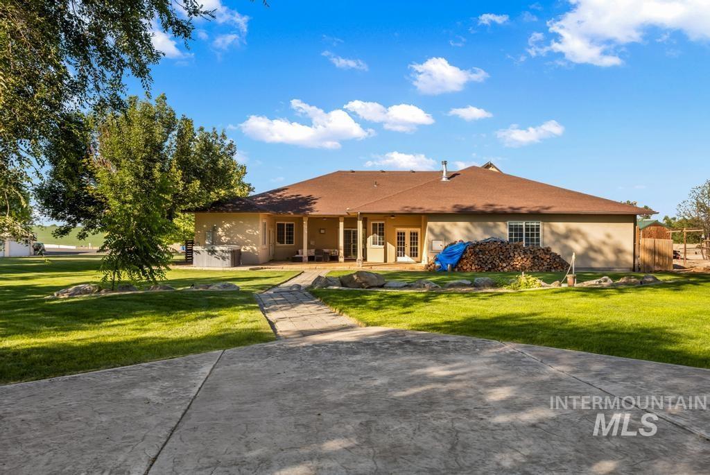 28279 Pearl Road Parma, ID 83660 - Photo 2 of 46 Rear view of house with a lawn, a patio area, and stucco siding