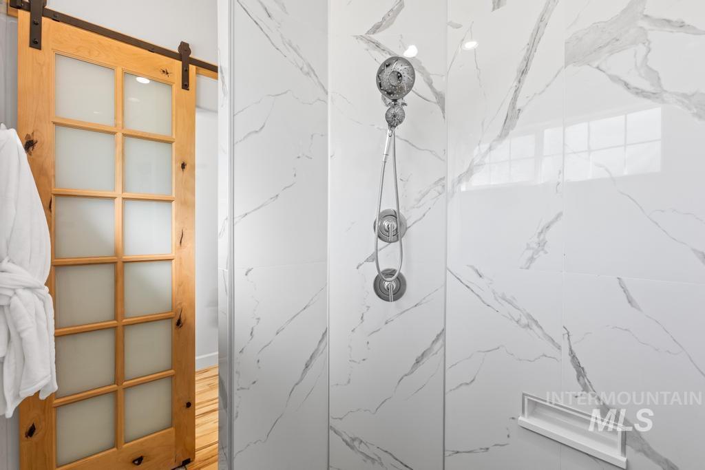 28279 Pearl Road Parma, ID 83660 - Photo 21 of 46 Bathroom featuring a marble finish shower and wood finished floors