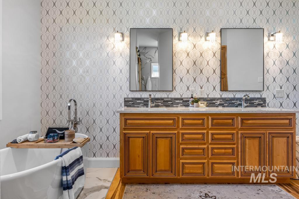 28279 Pearl Road Parma, ID 83660 - Photo 22 of 46 Full bathroom featuring a freestanding bath, double vanity, and light marble finish flooring