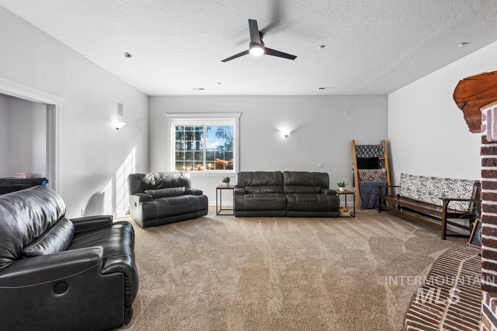 28279 Pearl Road Parma, ID 83660 - Photo 28 of 46 Living area featuring carpet, a textured ceiling, and ceiling fan
